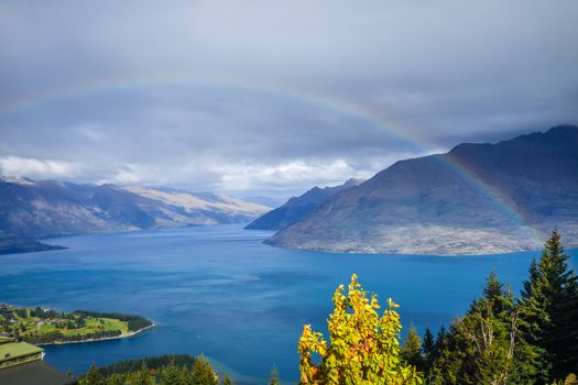 Rainbow on Lake Wakatipu and Queenstown panorama, New Zealand