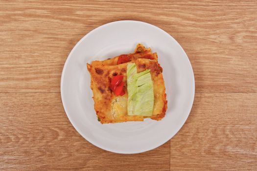 Lasagna with vegetables on a wooden table