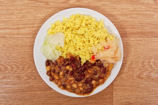 Red beans with curry rice on a wooden table