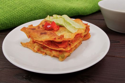 Lasagna with vegetables on a wooden table