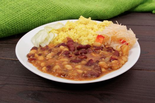 Red beans with curry rice on a wooden table