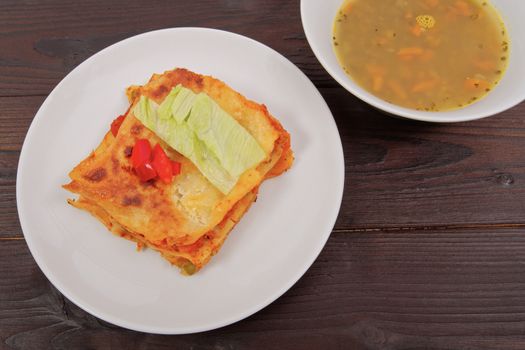 Lasagna with vegetables on a wooden table