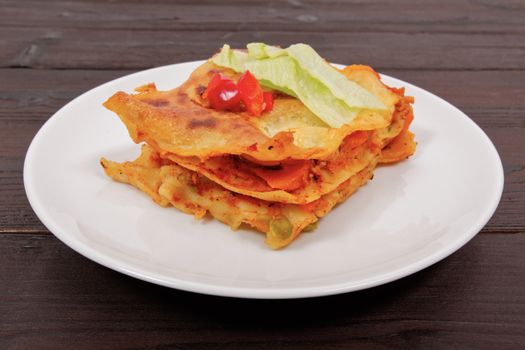 Lasagna with vegetables on a wooden table