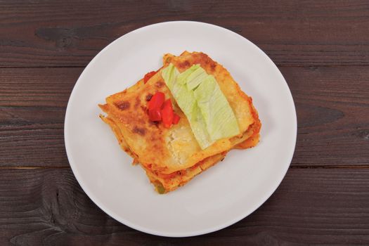 Lasagna with vegetables on a wooden table