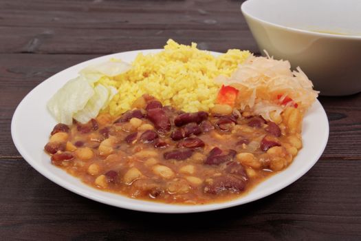 Red beans with curry rice on a wooden table