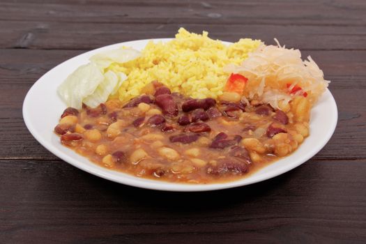 Red beans with curry rice on a wooden table