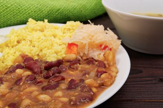 Red beans with curry rice on a wooden table