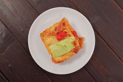 Lasagna with vegetables on a wooden table