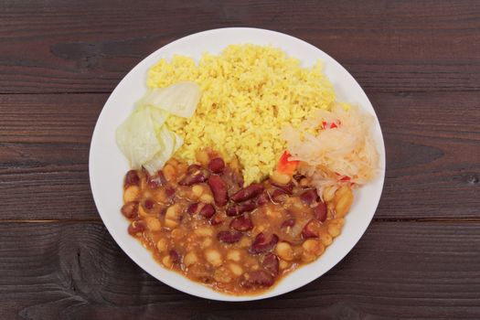 Red beans with curry rice on a wooden table