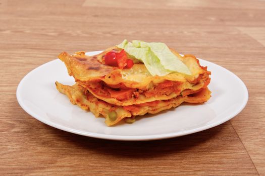 Lasagna with vegetables on a wooden table