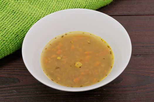 Lentil soup with carrots on a wooden table