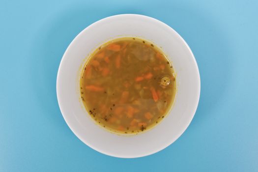 Lentil soup with carrots on a blue background