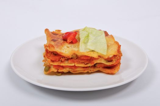 Lasagna with vegetables on a white background