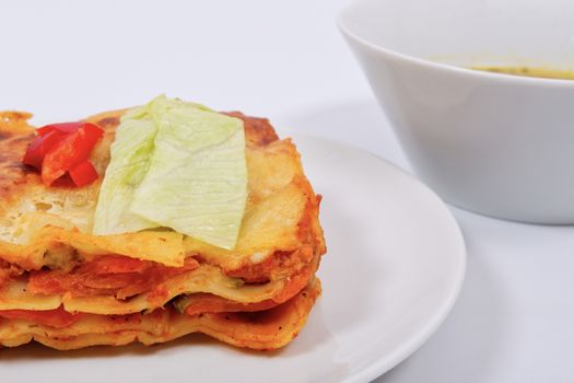 Lasagna with vegetables on a white background