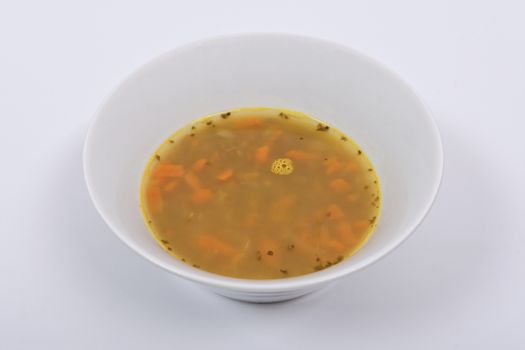 Lentil soup with carrots on a white background