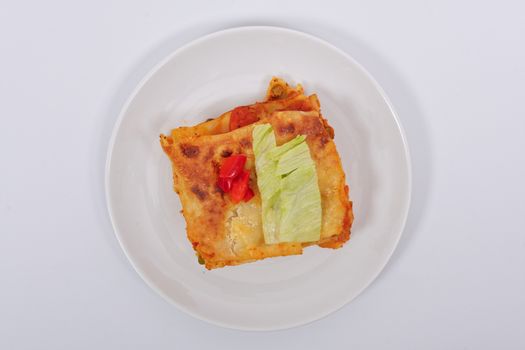 Lasagna with vegetables on a white background