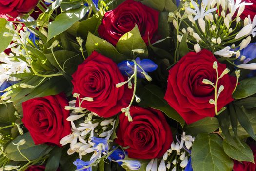 background of bouquet of flowers with red roses for memorial or wedding or even for condolence at a funeral
