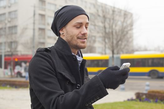 Traveling Man With Mobile Phone And Hat In City, Urban Space