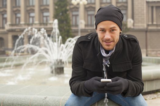 Traveling Man With Mobile Phone And Hat In City, Urban Space