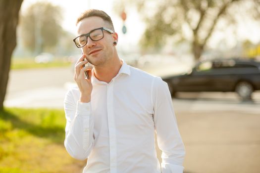 Man with glasses speak on mobile phone, In City, Urban Space, Park