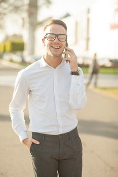 Man with glasses speak on mobile phone, In City, Urban Space, Park