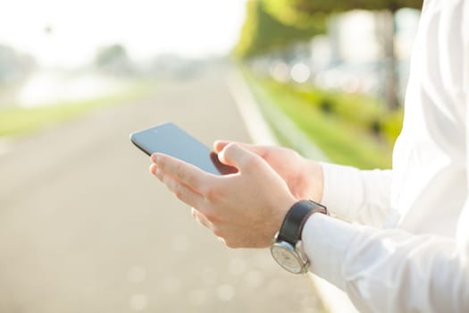 Close up of young man hands using touchscreen on digital tablet