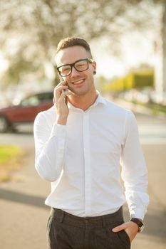 Man with glasses speak on mobile phone, In City, Urban Space, Park