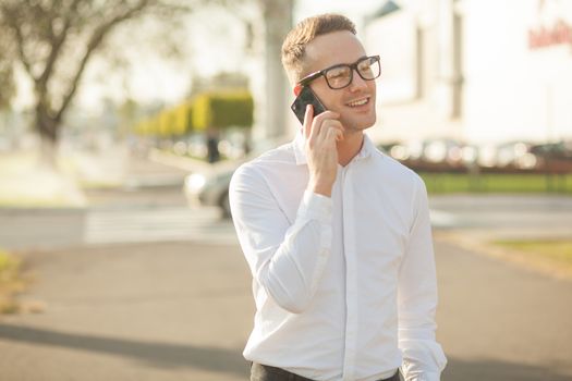 Man with glasses speak on mobile phone, In City, Urban Space, Park