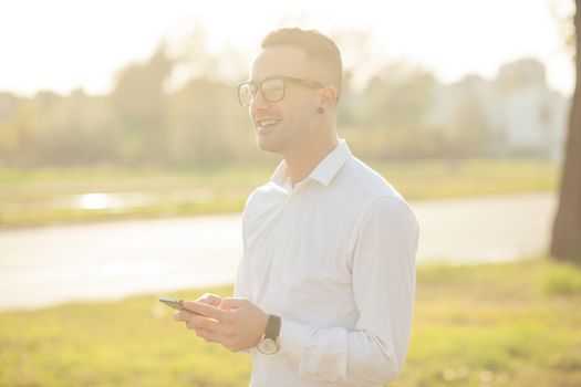 Man with glasses speak on mobile phone, In City, Urban Space, Park