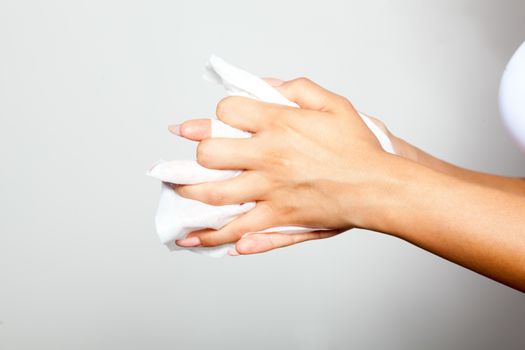 Young woman cleaning hands with wet wipes