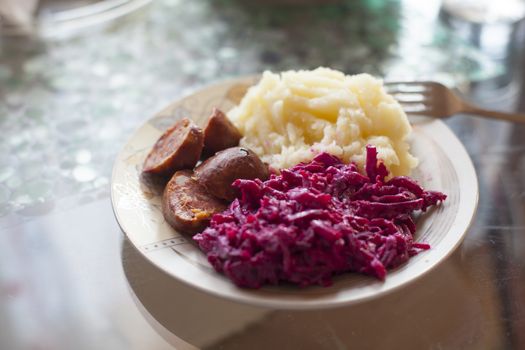 Meat sausage with potato puree and salad of beet