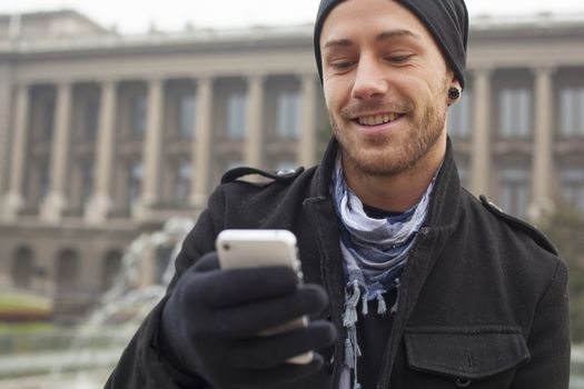 Traveling Man With Mobile Phone And Hat, In City, Urban Space