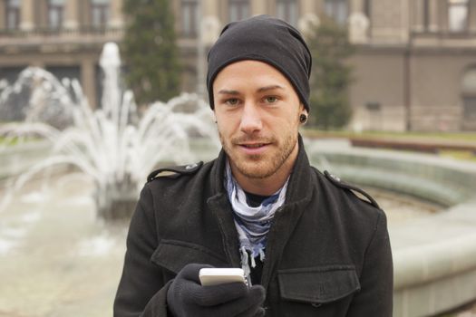 Traveling Man With Mobile Phone And Hat In City, Urban Space