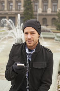 Traveling Man With Mobile Phone And Hat In City, Urban Space