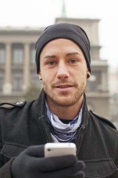 Traveling Man With Mobile Phone And Hat, In City, Urban Space