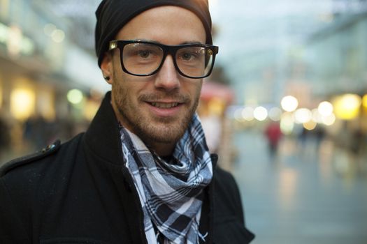 Portrait of fashion man on street, blurred city background