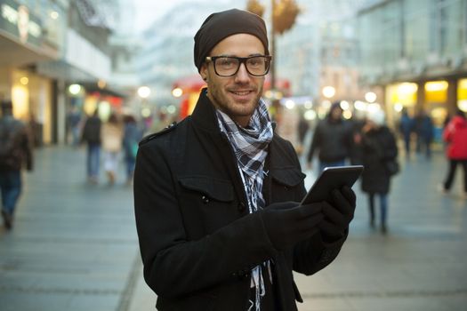 Young man searching information using an tablet computer.