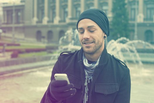 Traveling Man With Mobile Phone And Hat, In City, Urban Space