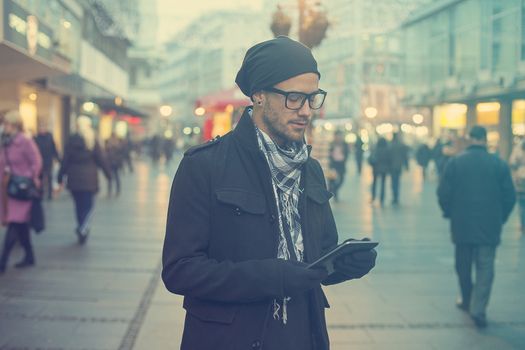 Young man searching information using an tablet computer.