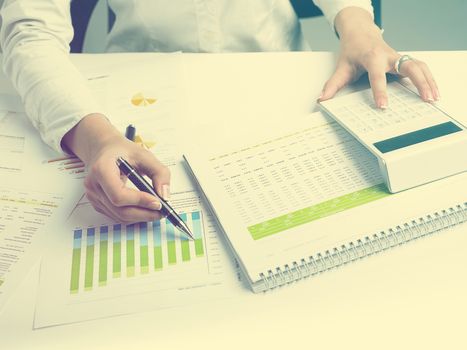 Market Analyze - pen and calculator on papers