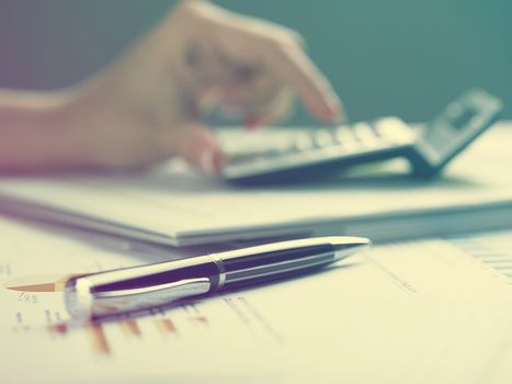 Market Analyze - pen and calculator on papers