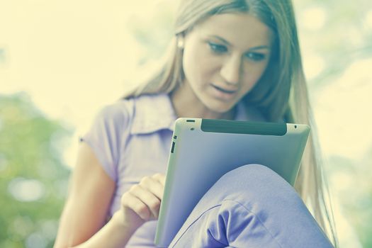 Beautiful Young Woman With Tablet Computer In Park