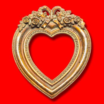 Old memories - gold heart shape picture frame on red background