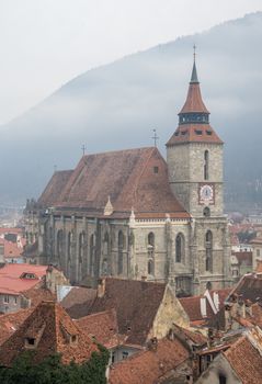 Black Church in a Brasov old town in a foggy winter day. Transylvania, Romania