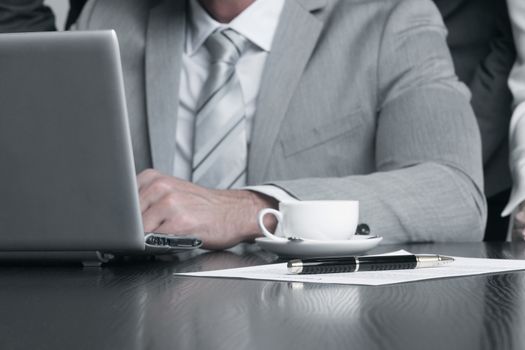 Group of business people working together with laptop at meeting