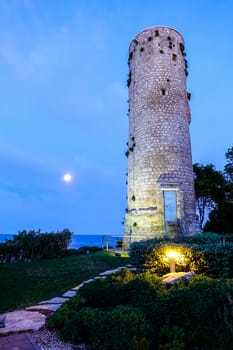 Ancient traditional stone lighthouse in dawn, oldest lighthouse in the Adriatic sea on Sveti Nikola island near Porec, Croatia