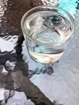 Closeup drinking water on glass table.