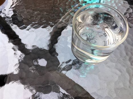Drinking water and ice in glass on the table