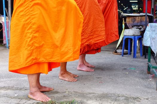 Buddhist monks are blessing,The orange tones of monk costumes in Buddhism.