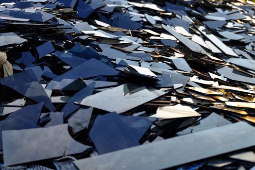 Broken black glass,Heap of mirror fragments,broken black mirror to recycle.